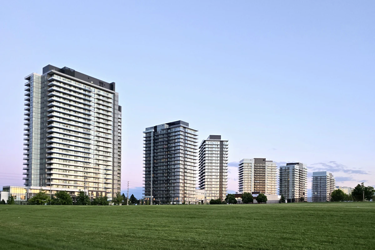 Multi-story residential condominium building with balconies and landscaped grounds