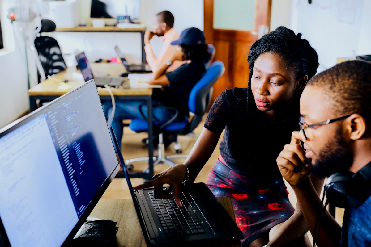 Diverse team of business employees collaborating around office workspace