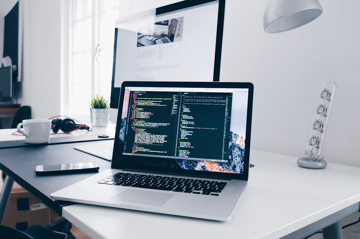 Technology developer workspace with laptop code and coffee