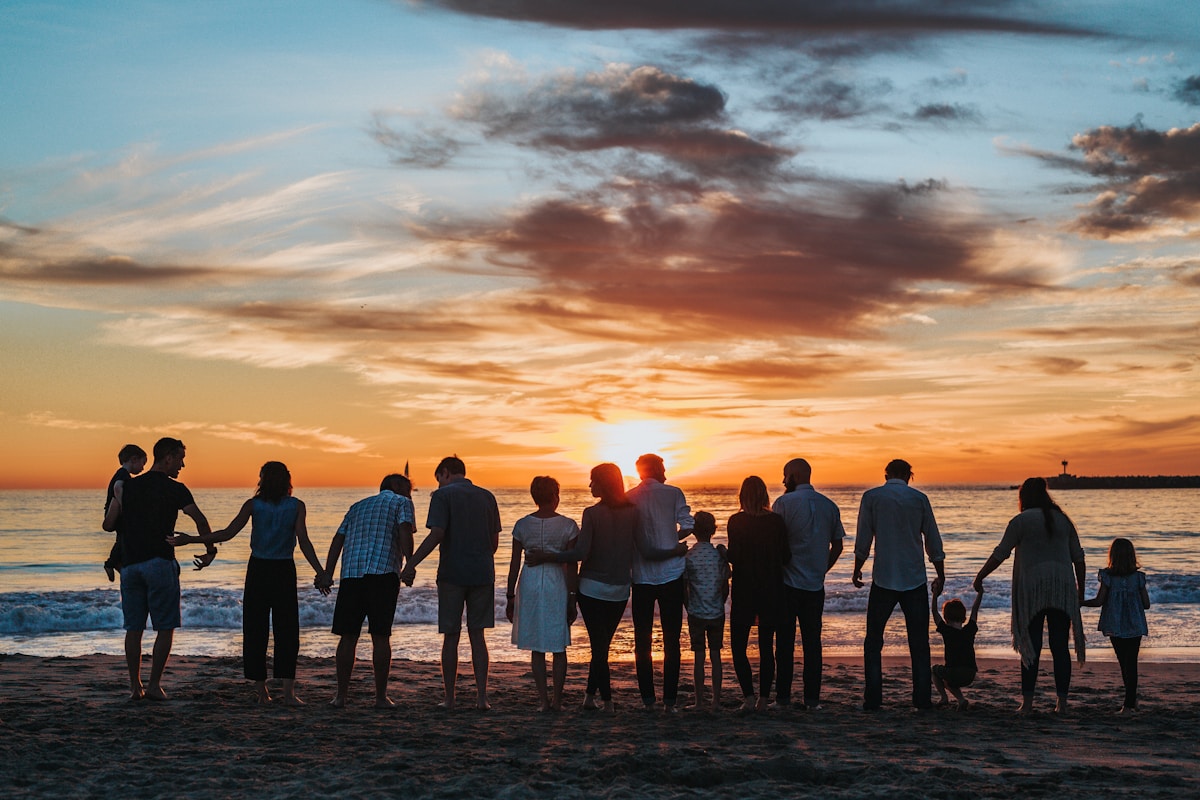 Family walking together in natural sunlight holding hands